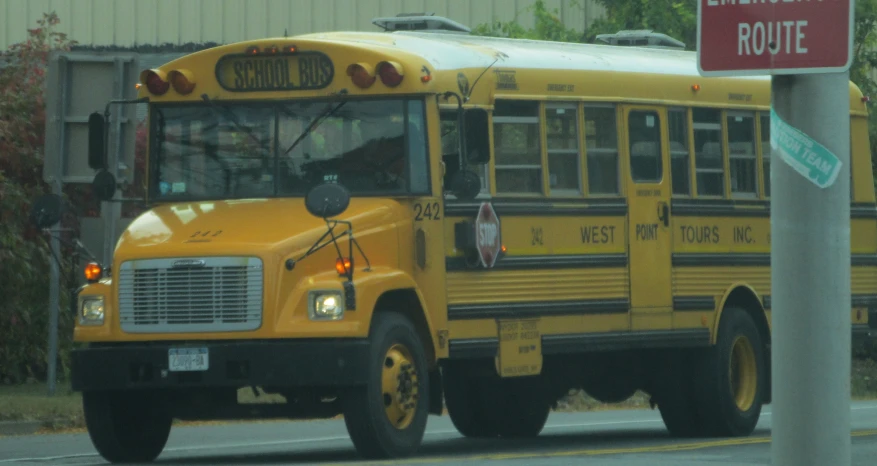 a school bus is driving down the street