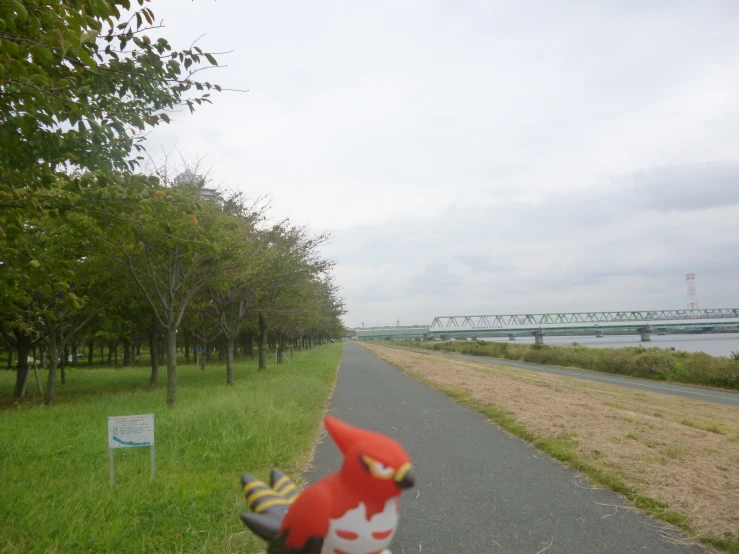 a plastic animal balloon on the road next to a bridge