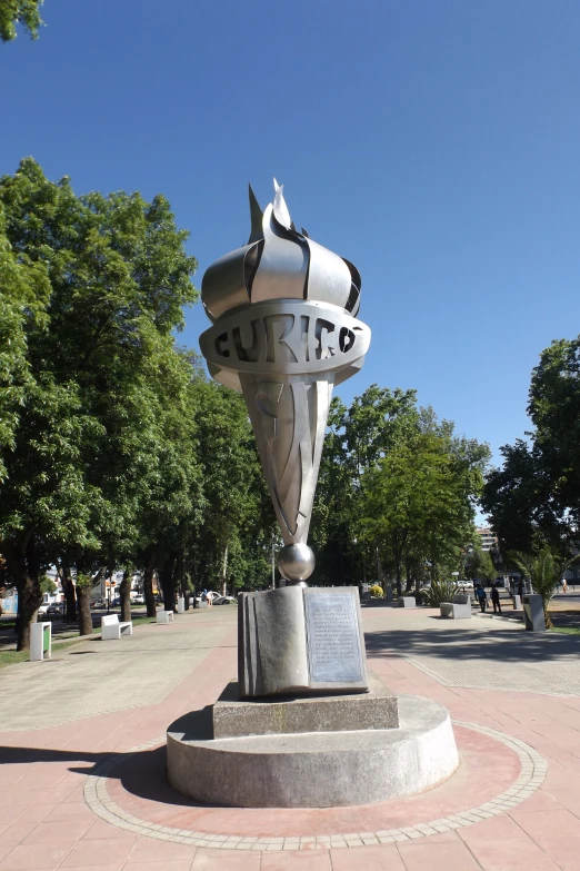 a silver statue with words on the head