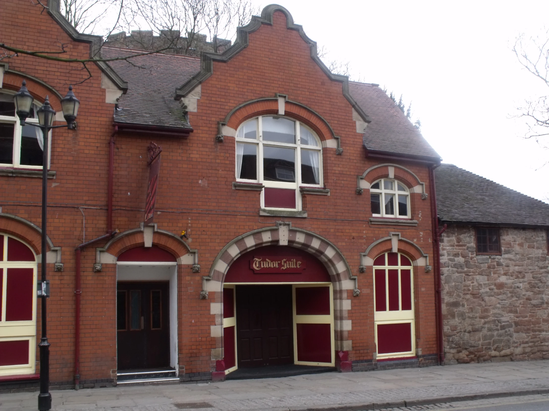 a building made of red brick and white windows