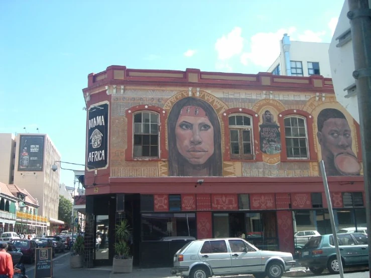 a red building with a mural on the side