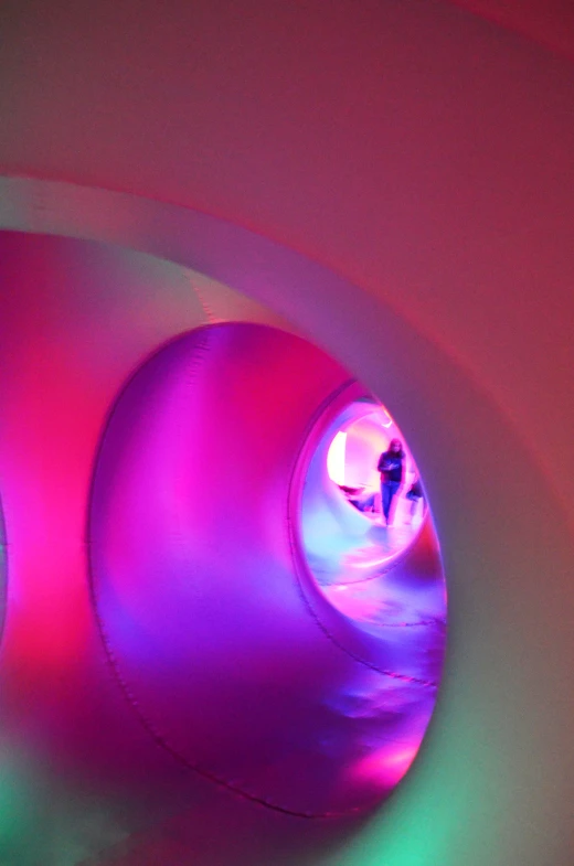 the view of a red and purple light in a dark room