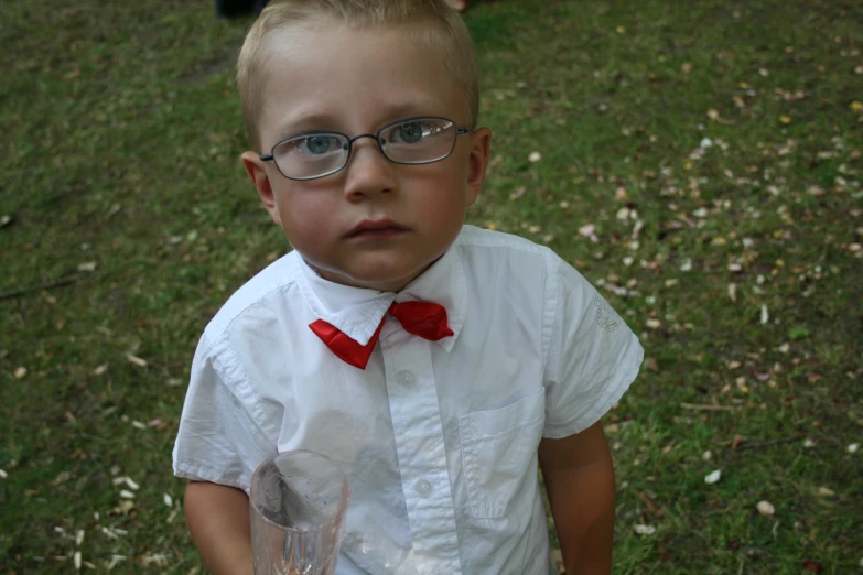 a boy wearing glasses and a bow tie