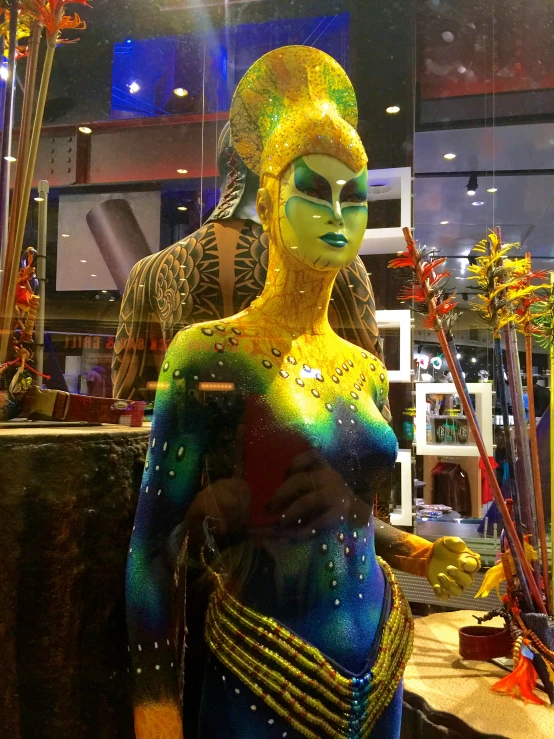 a girl in a body paint costume posing