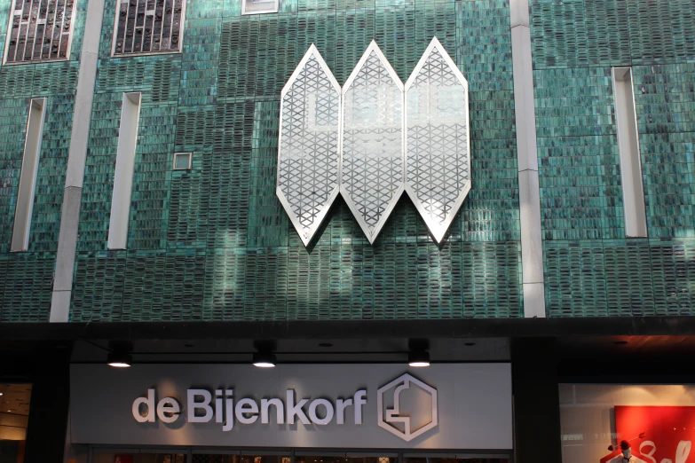 a store front with metal artwork that features white fish