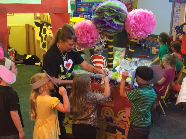 children at school eating out of some large balloons