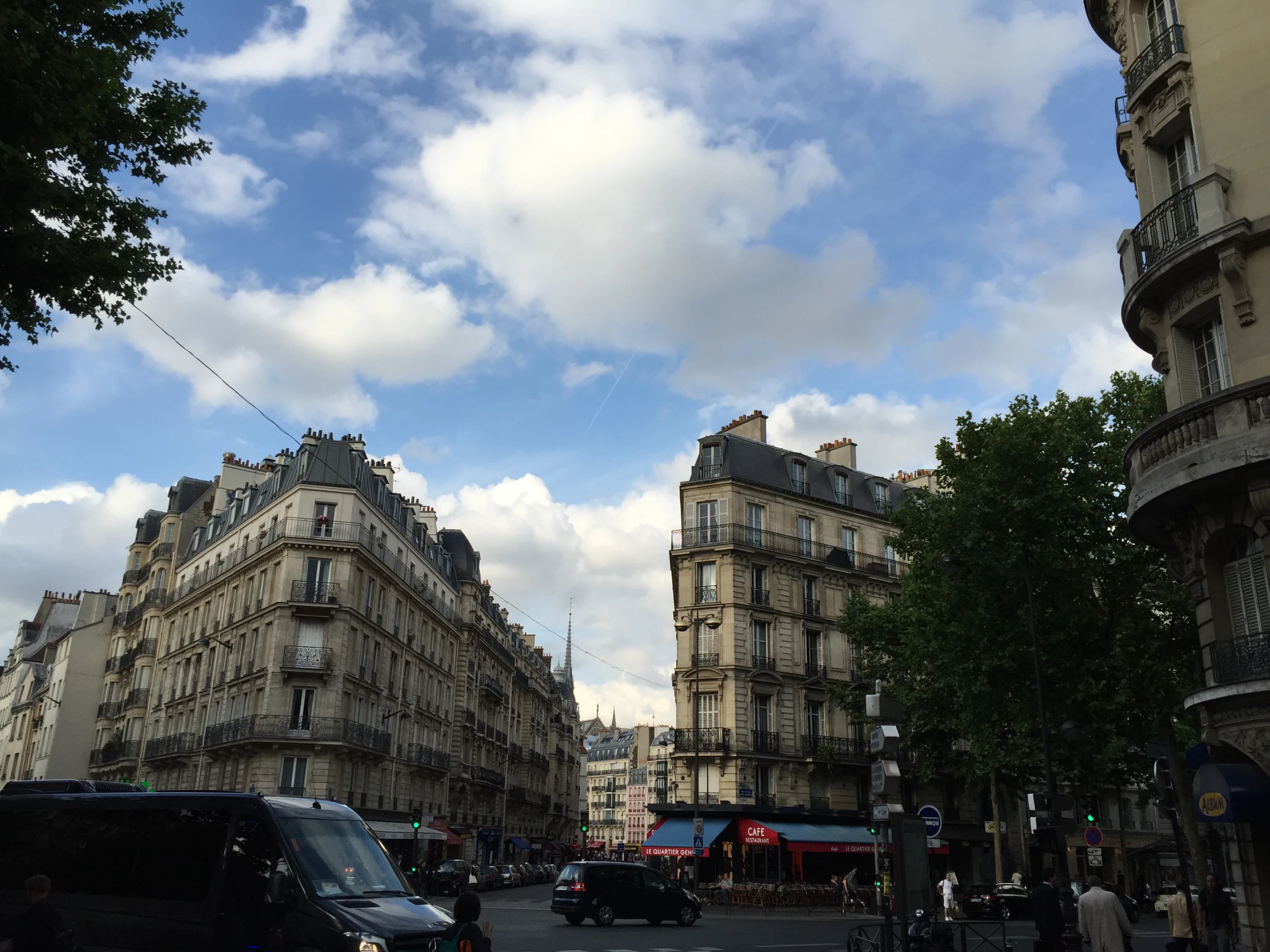 a group of buildings on the corner of a busy street