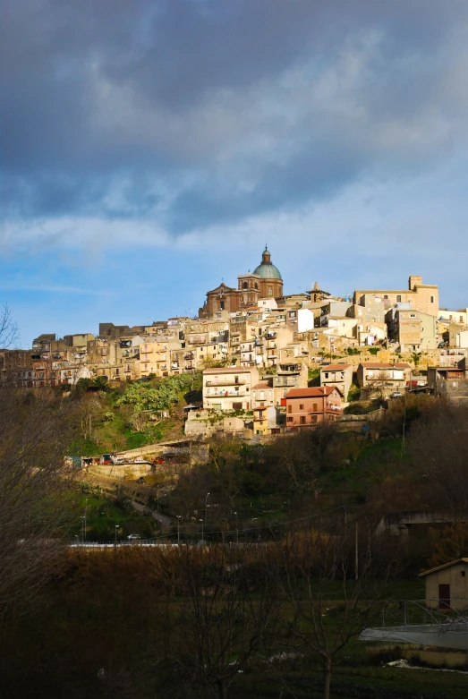 a view of a town on top of a hill