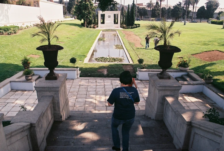 a person taking a picture from above an outdoor walkway