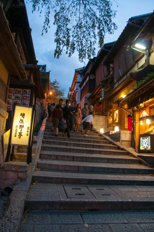 people walking down some stairs to an asian restaurant