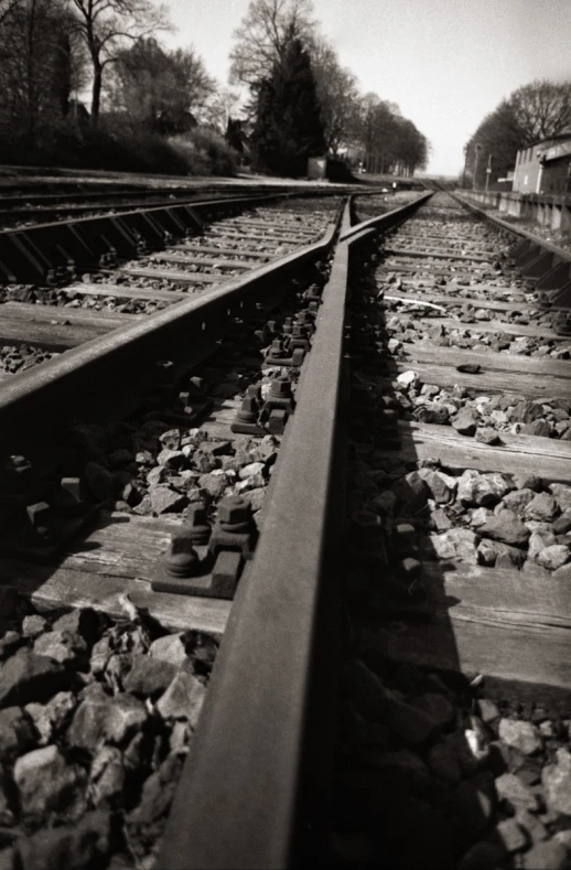 black and white po of train tracks running parallel