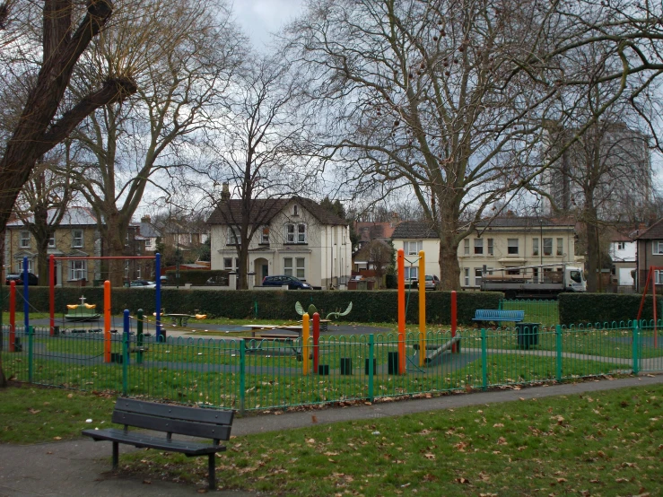 a playground has many swing rings and poles