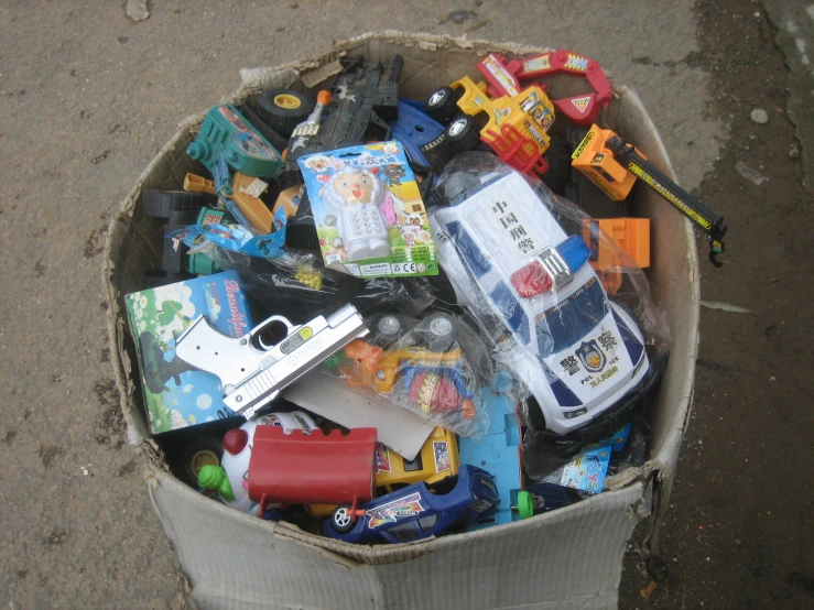 a cardboard box full of toys and car parts