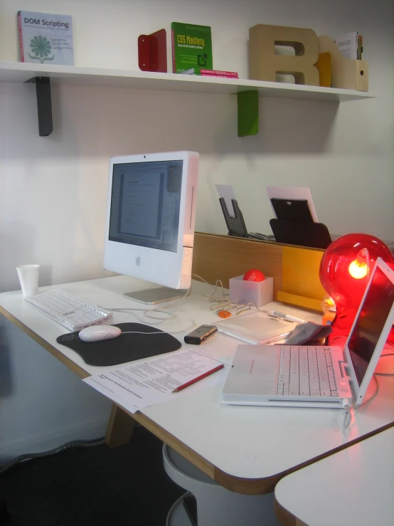 an office desk with a computer on top