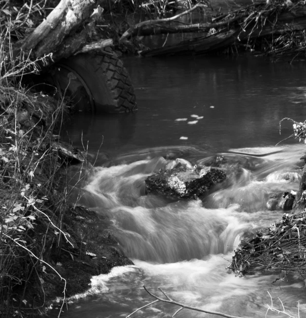 a flowing river that flows from it through grass