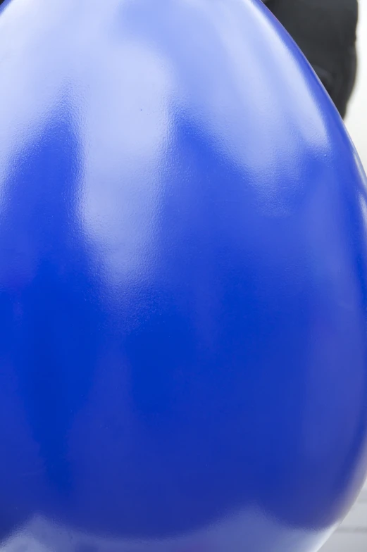 large blue balloon stuck in a white pole