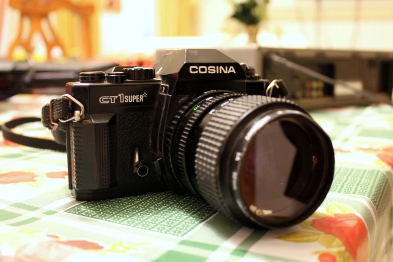 an old - fashioned camera with an open lens is displayed