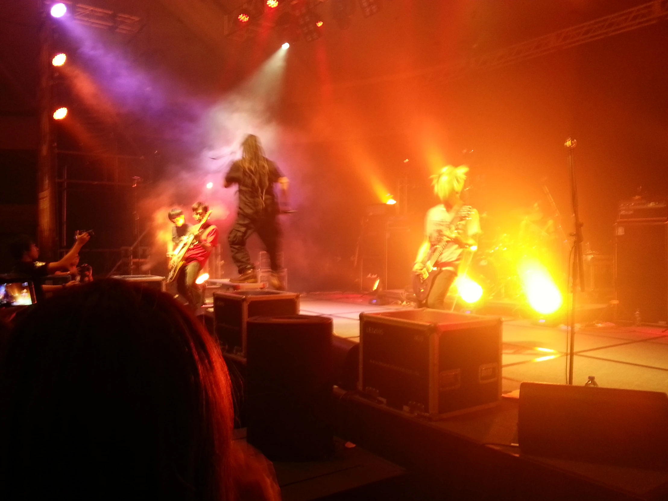 a band performing on stage with a red light