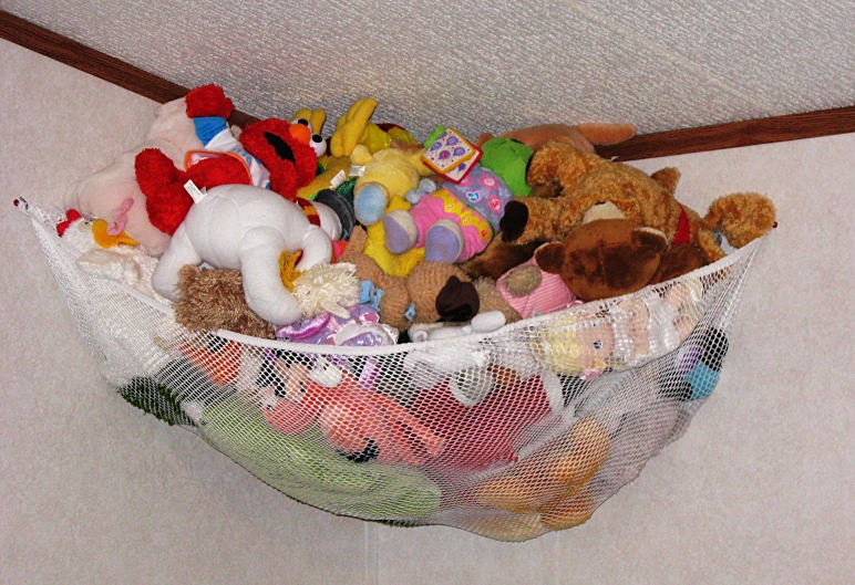 there are many stuffed animals in a small net