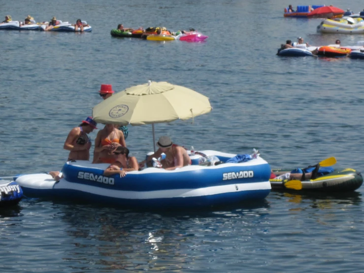 people riding in a small boat with an umbrella