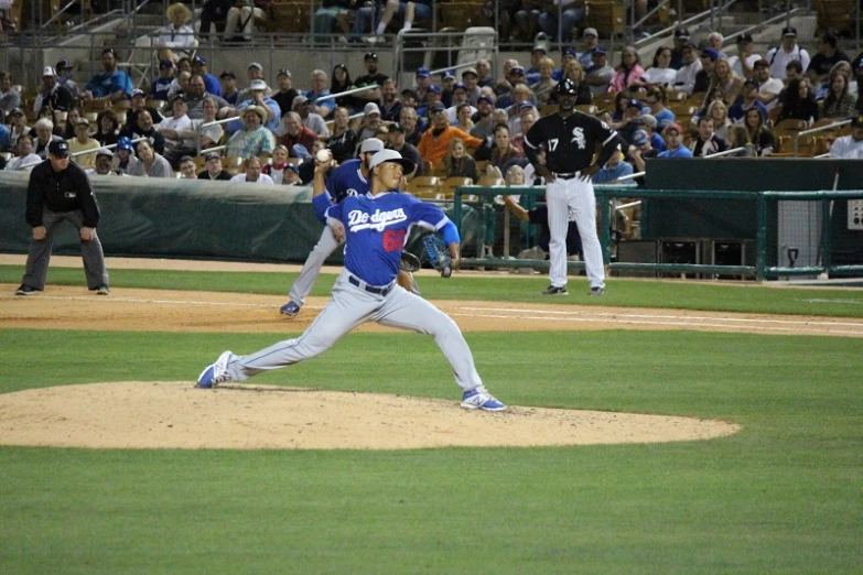 a pitcher throws a baseball while the batter is ready