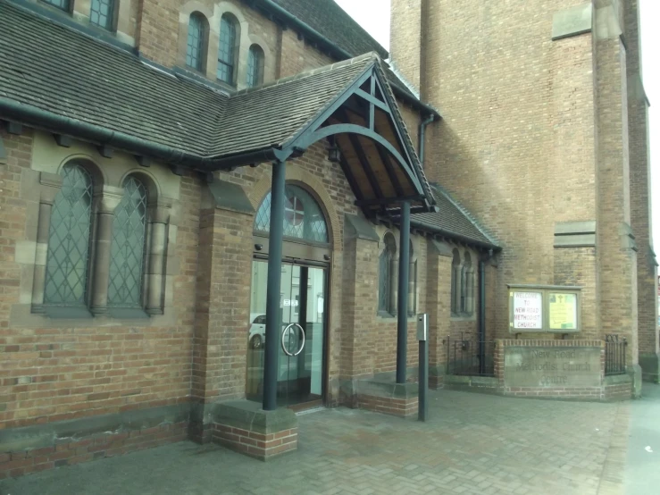 a brick church has a decorative door and window trim