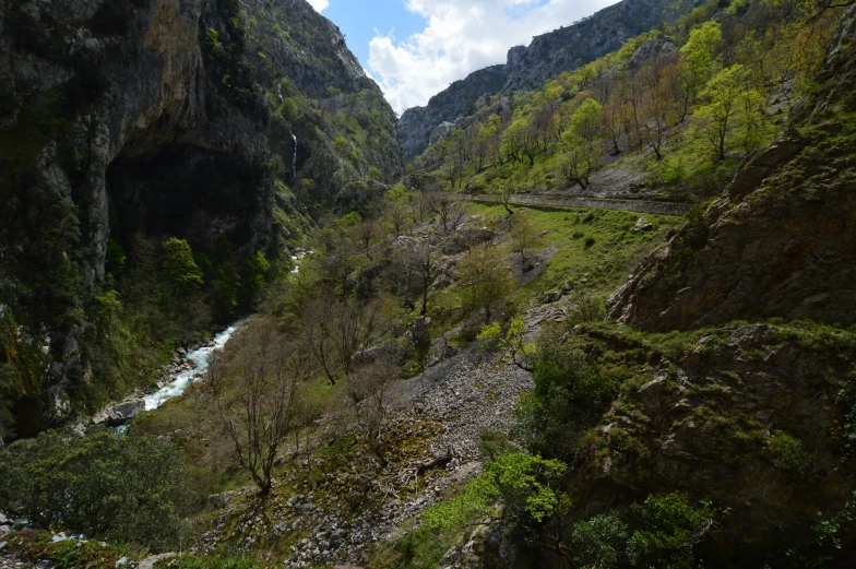 the view from inside the mountain looking up at a narrow mountain stream