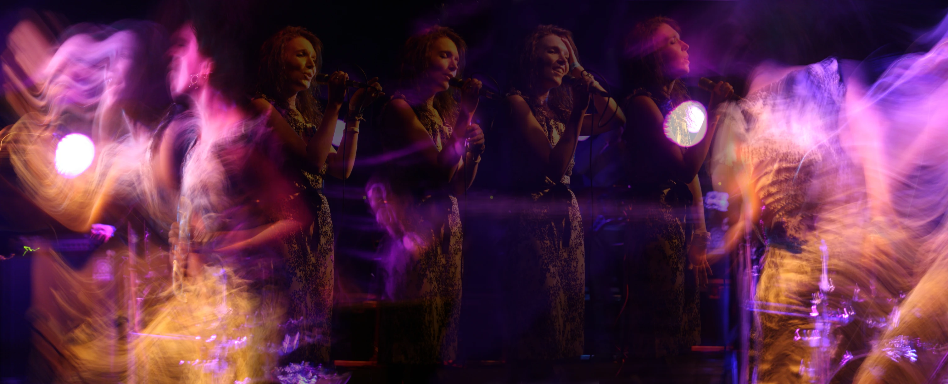 a group of women in formal wear with lighted props