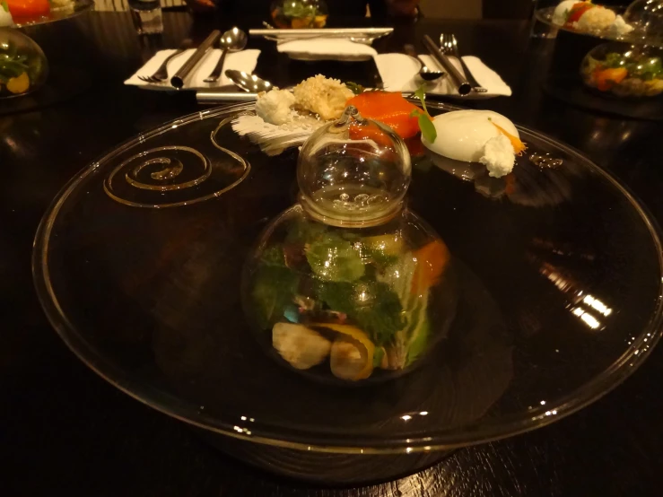 a plate that has a vase filled with food