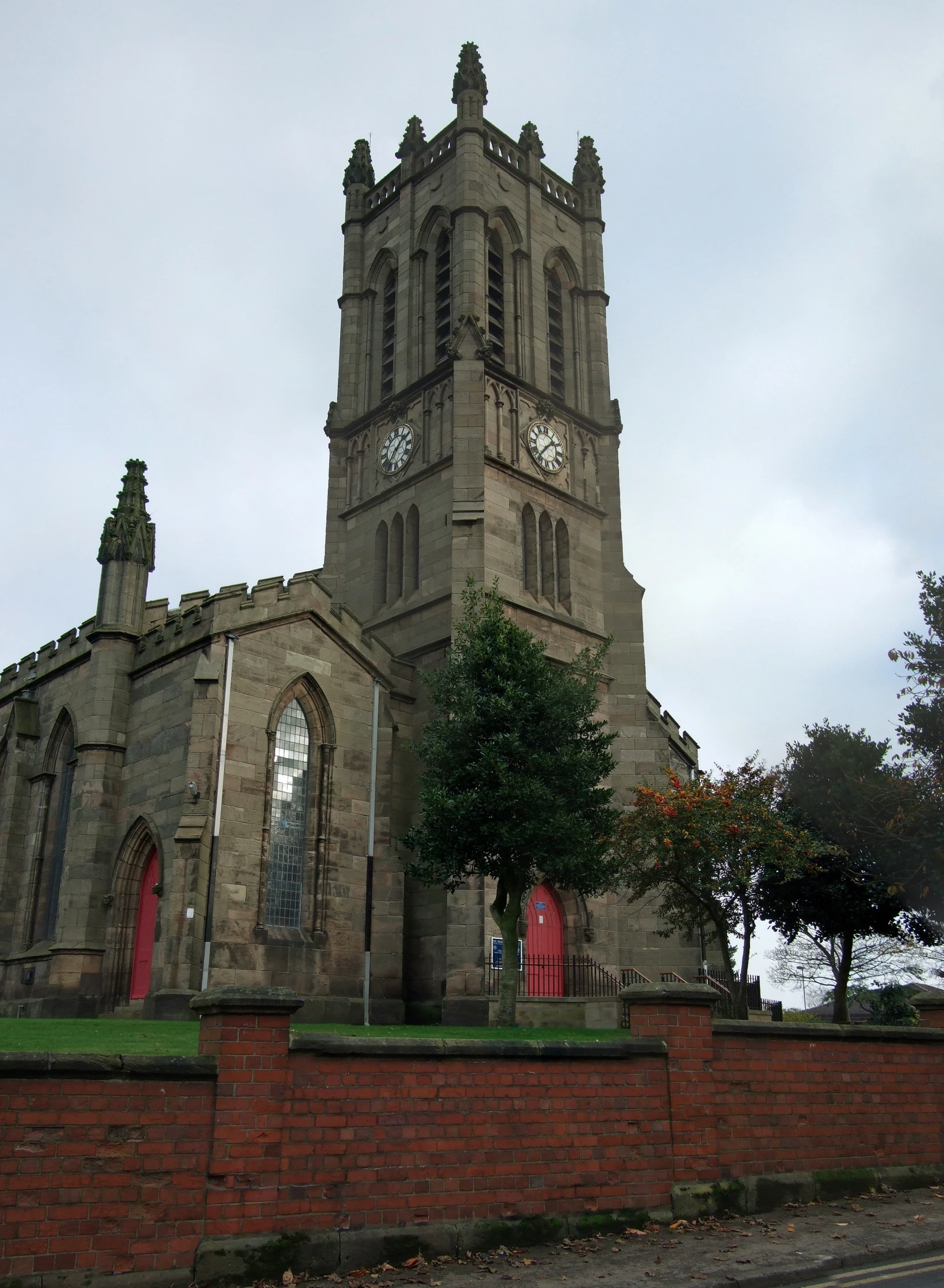 an old brick building with two clocks on the tower