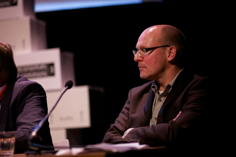 there are two men sitting down at a table