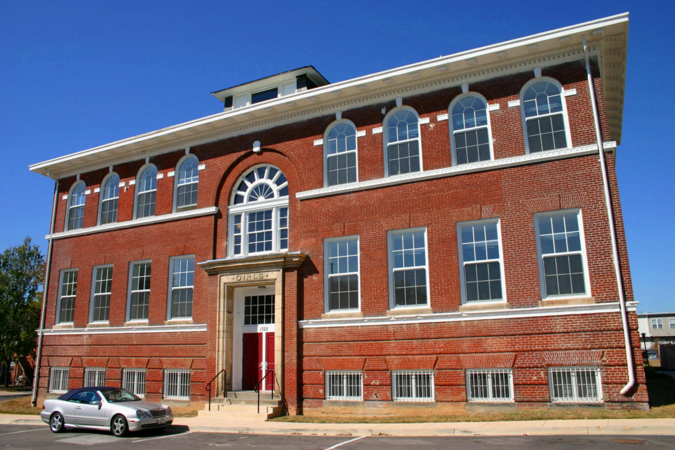 an old red brick building with lots of windows