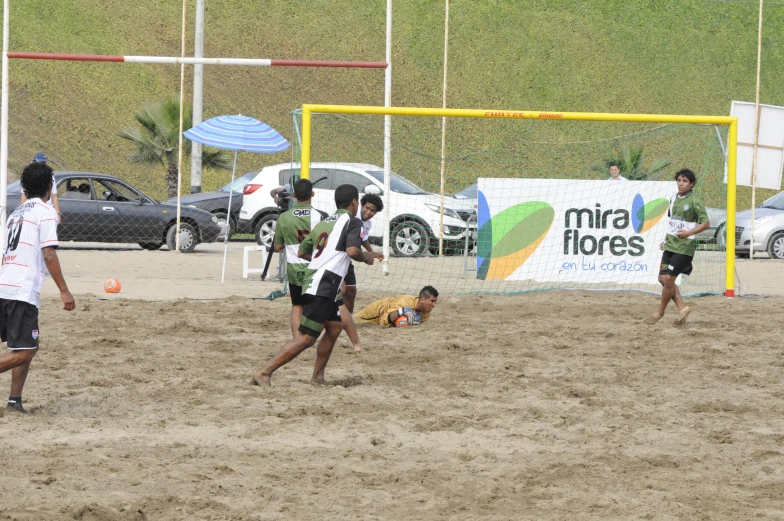 soccer players and spectators playing on the beach