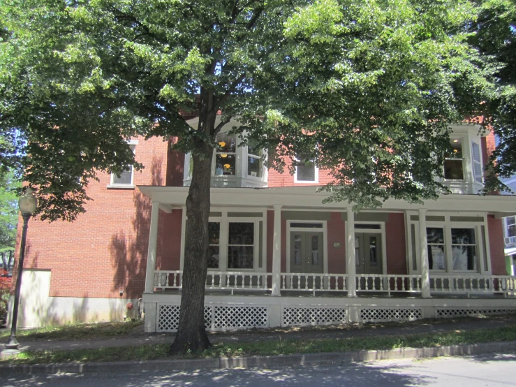 a big red building with two trees next to it