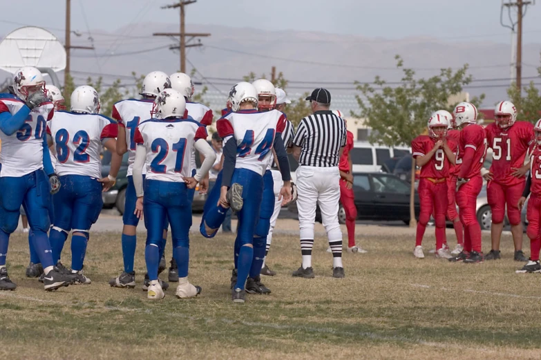 several people in uniform walking on the field