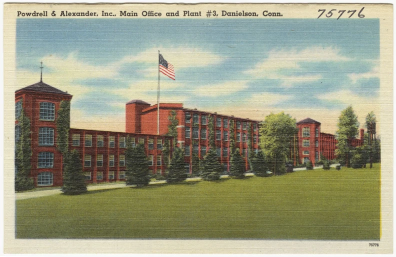 a building in a grassy field with an american flag on it