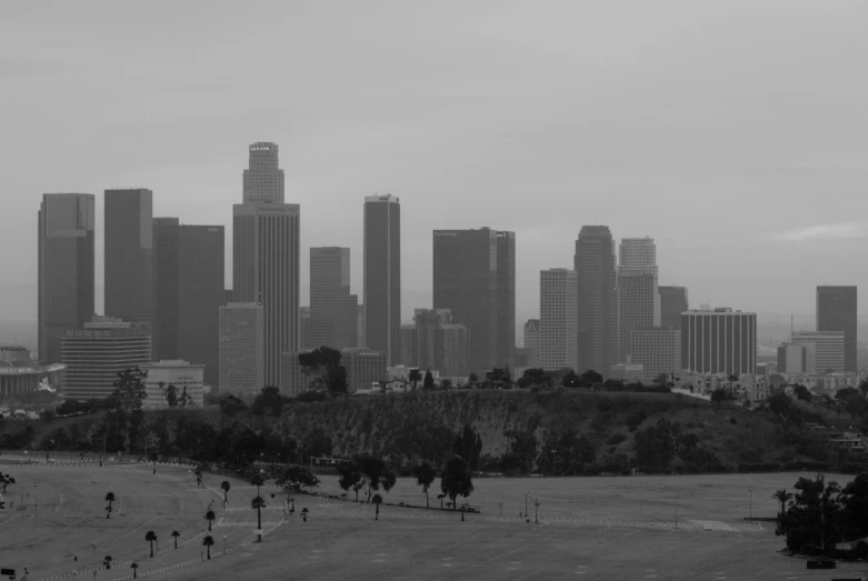 black and white po of people walking and buildings in the background