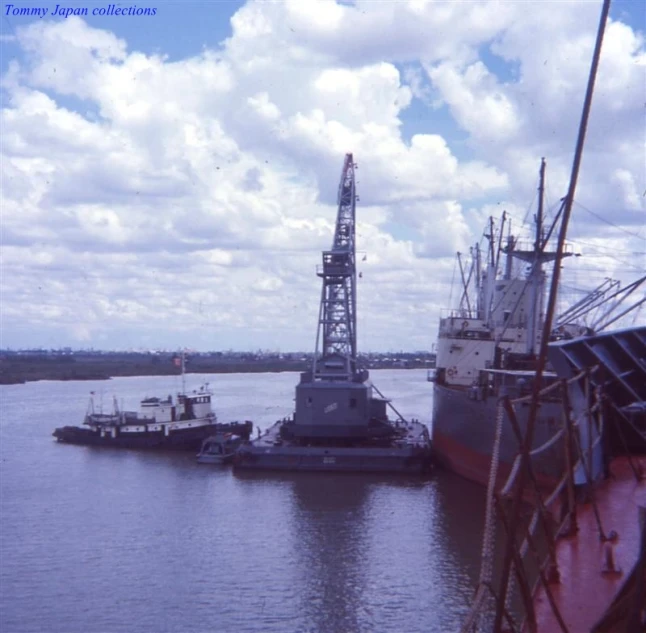 a crane next to a boat and another ship