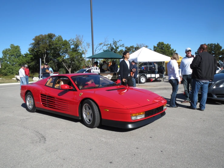 a red car is parked in a parking lot