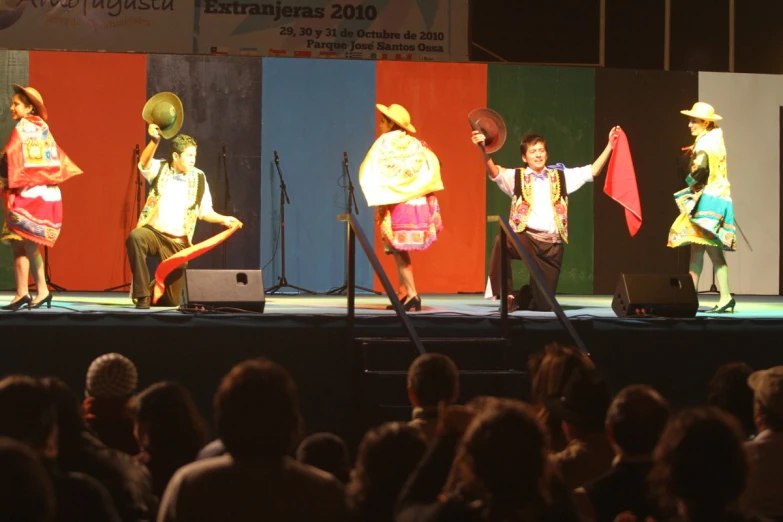 people are performing an oriental dance on a stage