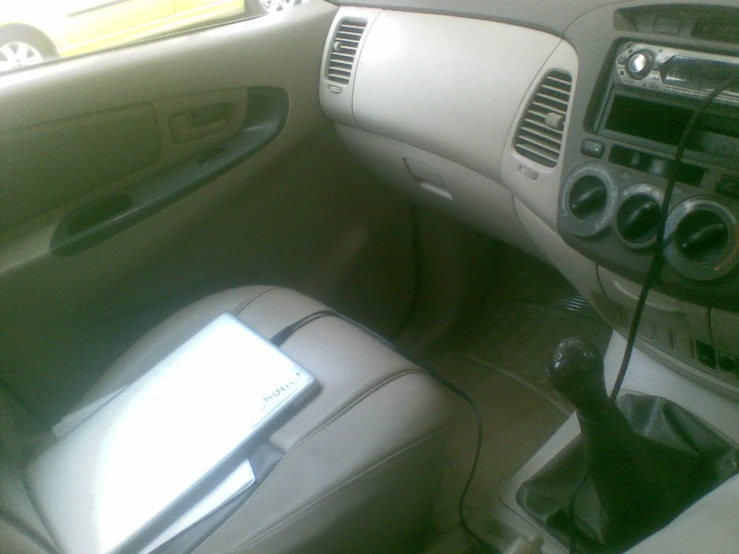 a cell phone is on the front console of a vehicle