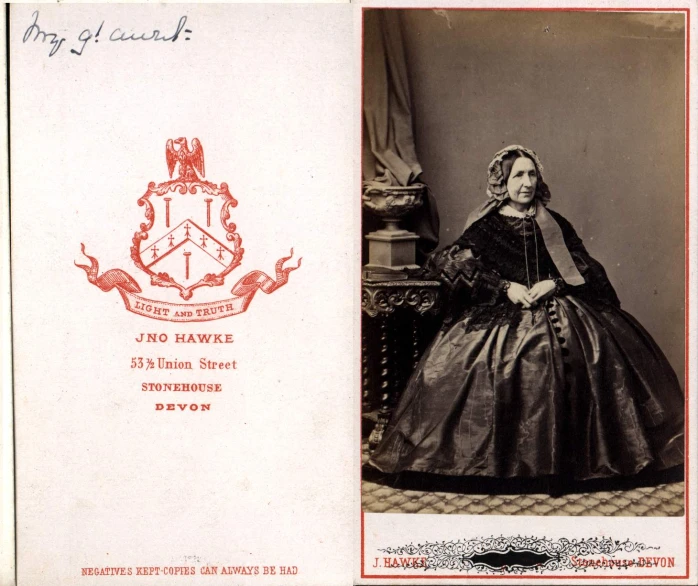 an old postcard with a woman in victorian dress sitting