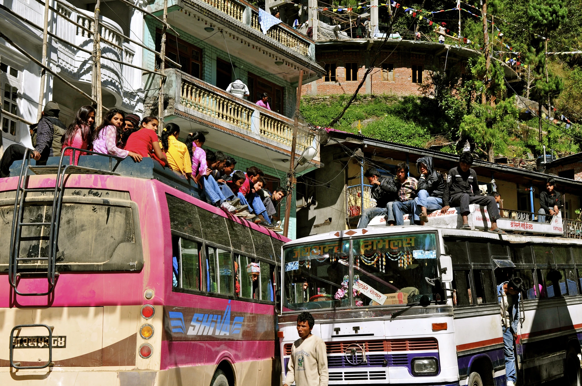 a group of people that are on the top of a bus