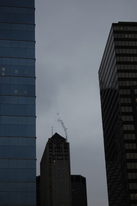 smoke is visible from the tall buildings as it burns