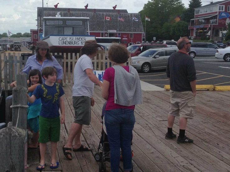 a group of people standing on top of a dock