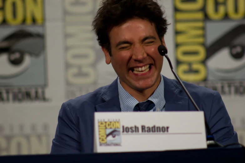 a man sitting in front of a microphone