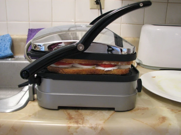 two sandwiches are sitting inside of the toaster