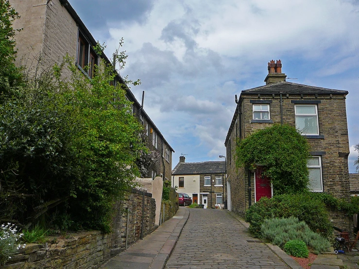 a quiet narrow alley with stone houses on the sides