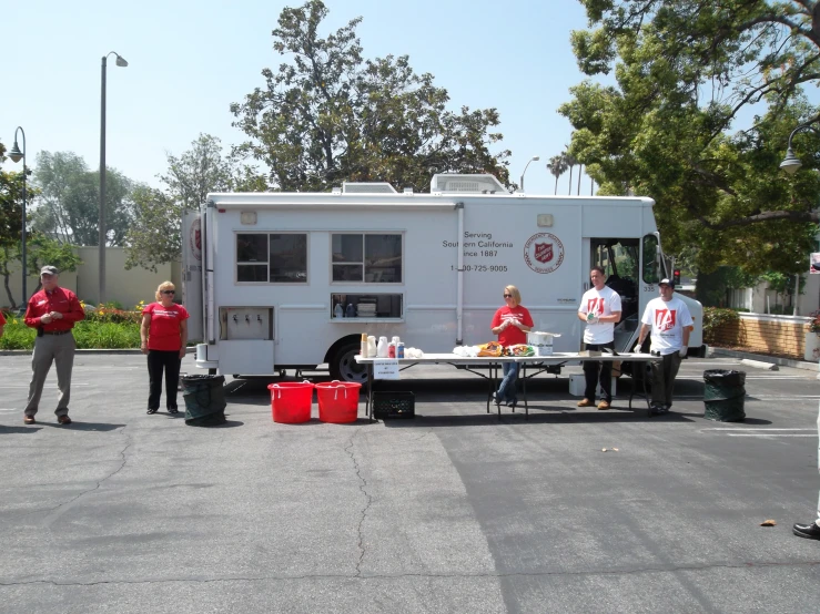 a group of people are standing in front of a mobile food truck