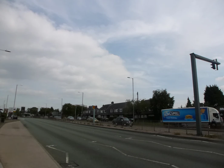 a truck is driving down a road with cars